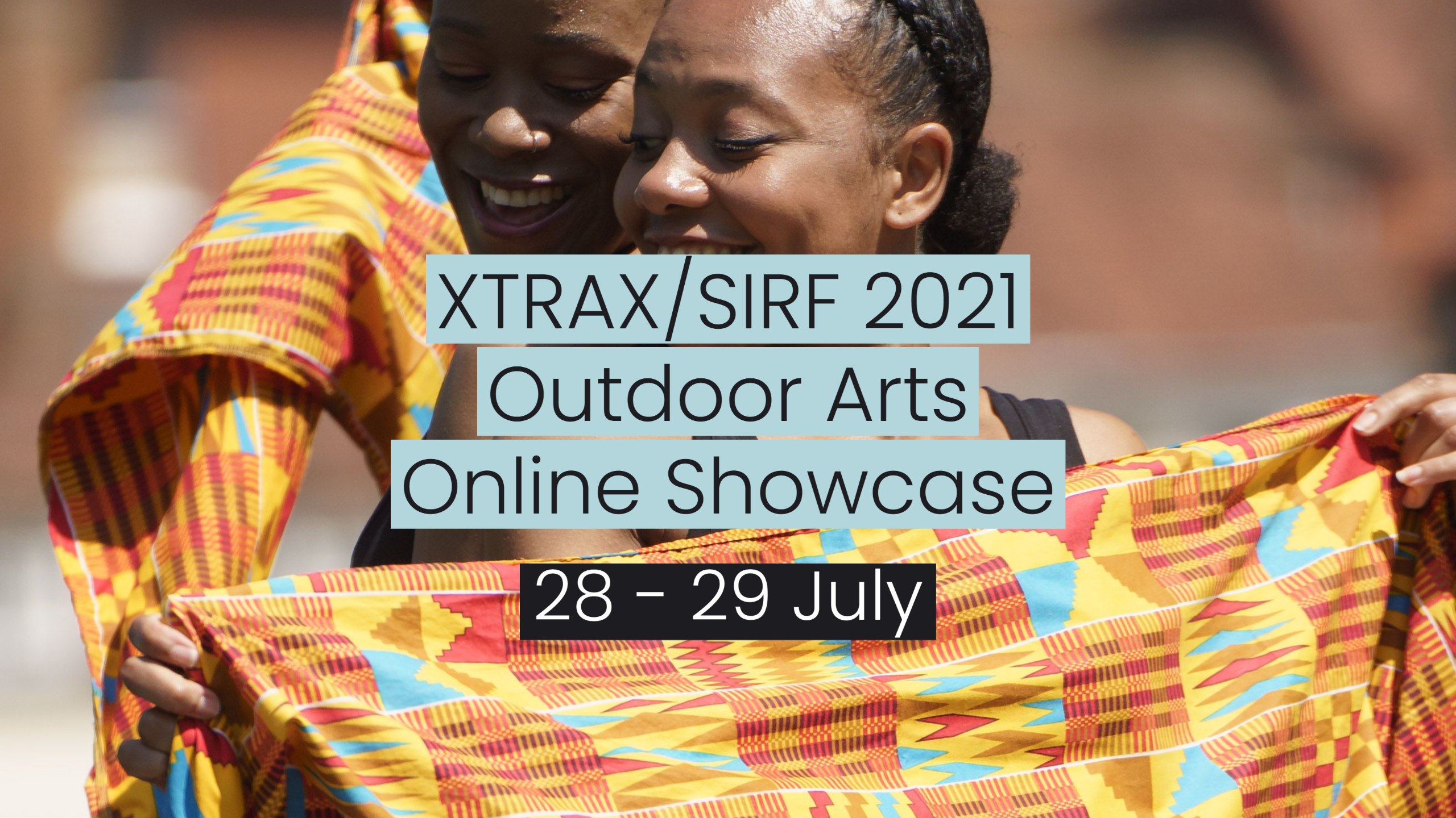 Two smiling women hold up colorful, patterned cloths. Overlaid text reads: “XTRAX/SIRF 2021 Outdoor Arts Online Showcase 28-29 July.”.