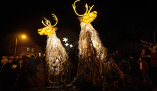 Two lanterns in the shape of deers, illuminated by light.