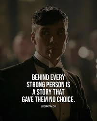 A man in a suit with a cigarette in his mouth stands in dim lighting. Overlaid text reads: Behind every strong person is a story that gave them no choice.